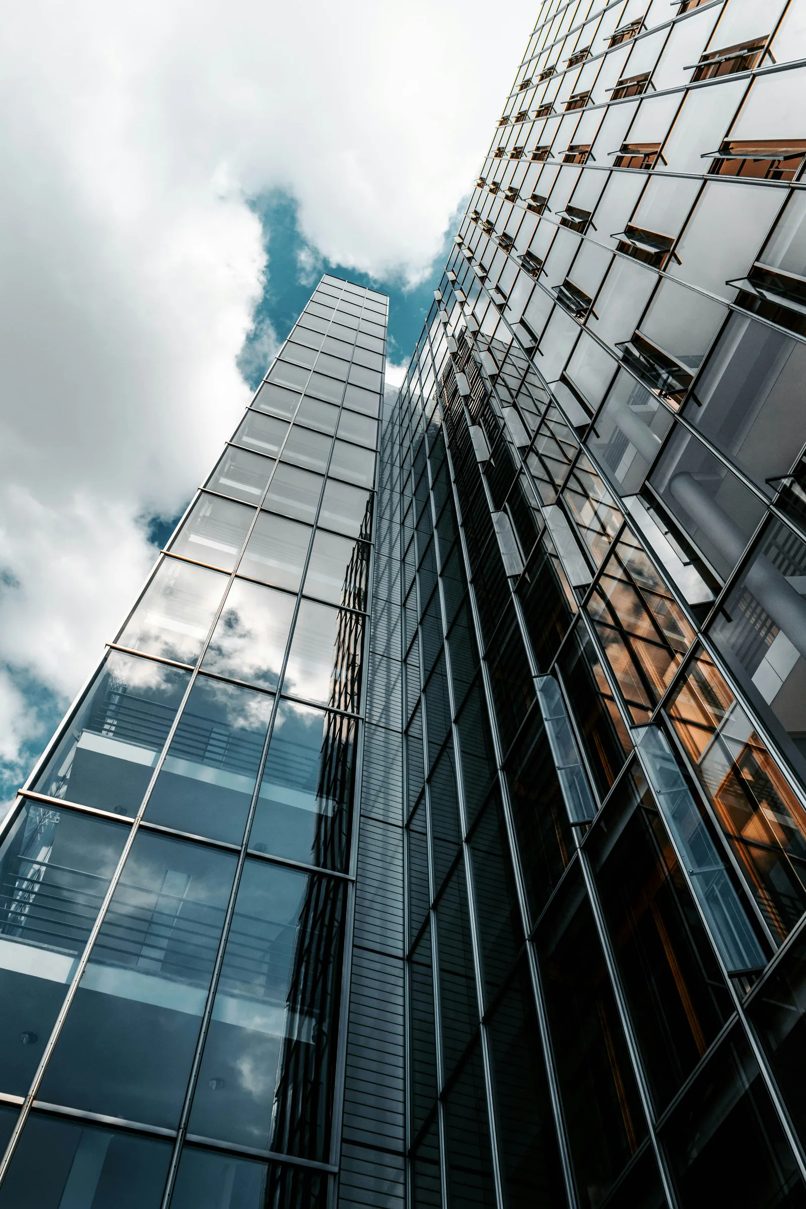 Modern glass office tower reflecting sky — Planeta Innovision Ltd. connects EU business and technology